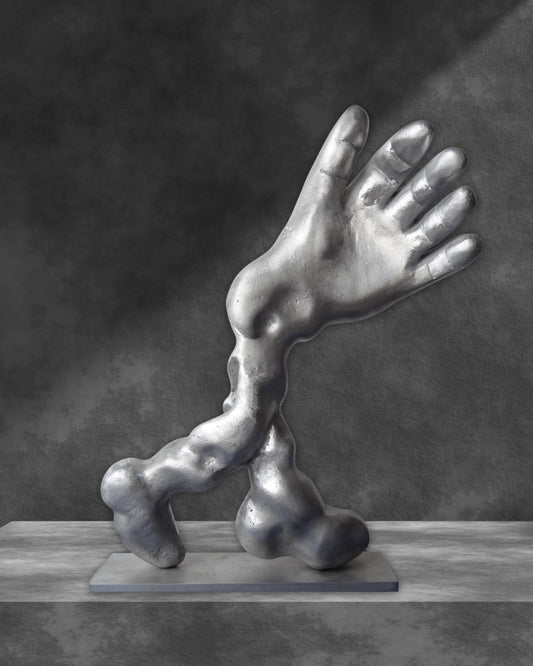 Aluminiumskulptur 'Salute' von Amos Plaut. Abstrakte Darstellung einer Hand und eines Arms, ruhend auf einer rechteckigen Basis. Höhe 41 cm.