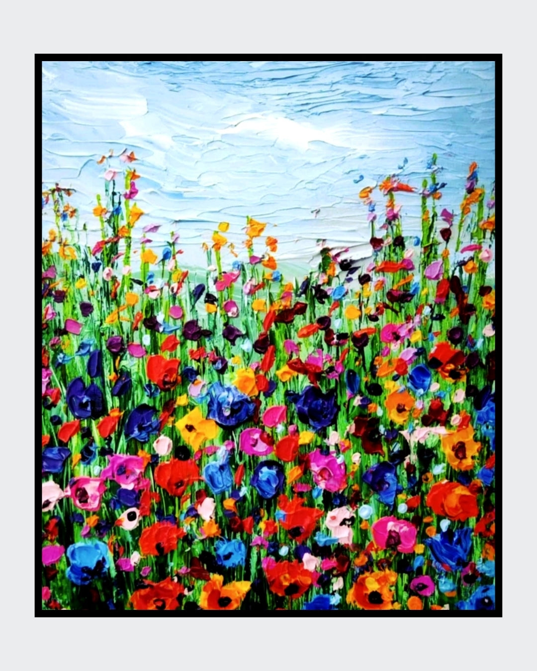 Ein farbenfrohes Gemälde zeigt eine Wiese voller wilder Blumen, die bis zum Horizont reicht. Der Himmel ist blau und wolkenlos. Die Blumen sind in verschiedenen Farben gemalt, darunter Rot, Pink, Blau und Gelb. Die dicke Farbschicht vermittelt eine lebendige und haptische Textur. Kunstwerk von Susanne Stepbach aus Wuppertal.